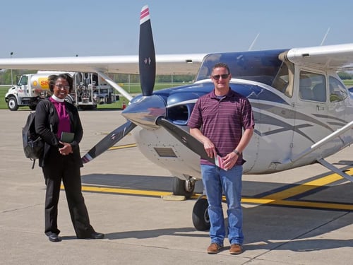 Bishop Jennifer Baskerville-Burrows and Marty pose with the plane following their PrayerFlight over Indianapolis and the surrounding suburbs.